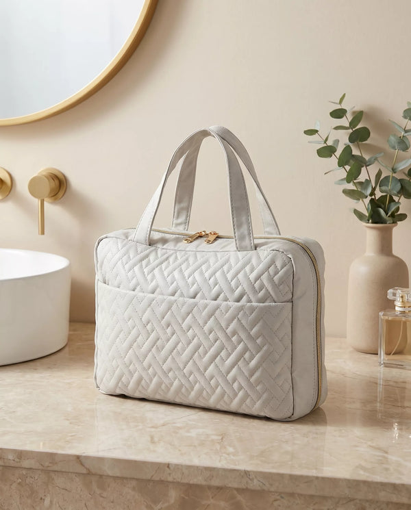 Travel vanity organizer folded into a quilted handbag with carry handles lifestyle