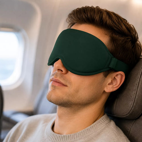 Man sleeping on a plane with WellMall 3D sleep mask